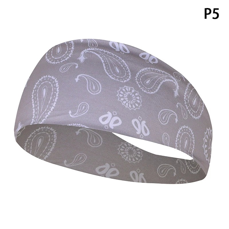 A gray elastic sports headband with a paisley and floral pattern shown from the side.