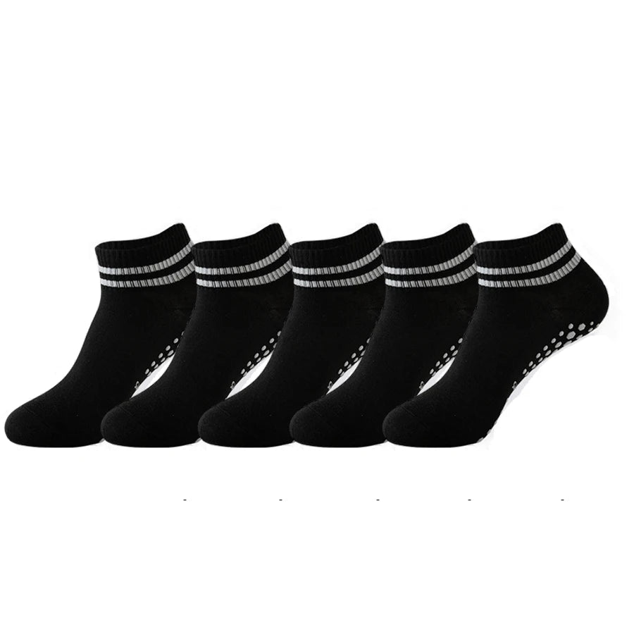 A row of black non-slip grip socks with silver trim laid out on a white background.