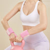 A woman wearing a pink wrist guard bandage while exercising.