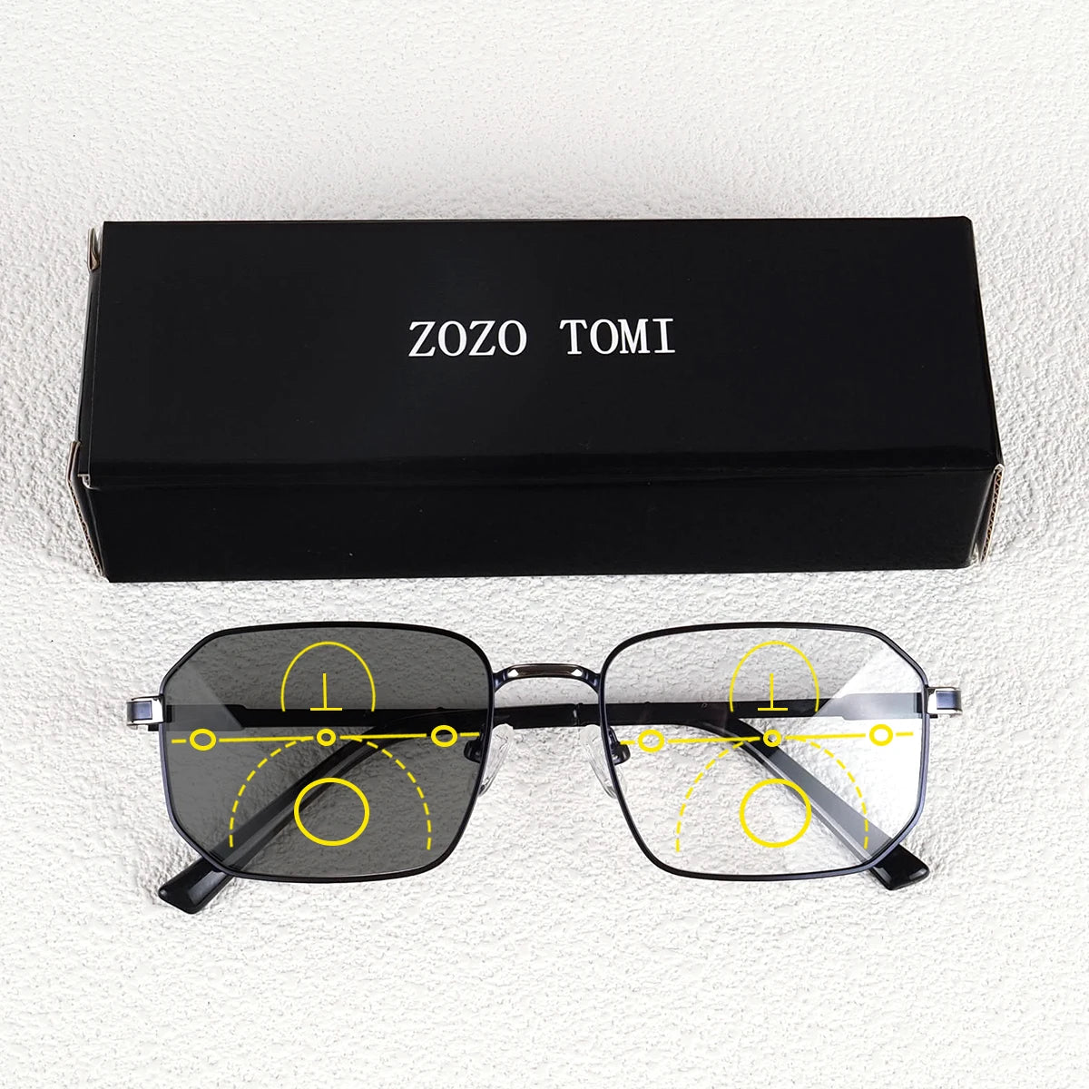 A pair of black photochromic progressive reading glasses are displayed next to their original box labeled ZOZO TOMI.