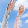 A pair of UV protection arm sleeves, one white and one pink, are shown against a blue sky with clouds.