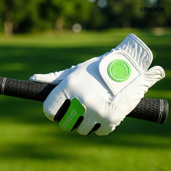 A white ergonomic golf glove with green accents is shown gripping a golf club against a blurred green background.