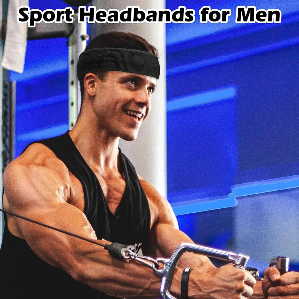 A muscular man wearing a black sports headband while exercising in a gym setting.
