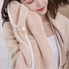 A woman wearing a beige fleece bath robe, highlighting its gentle texture and moisture absorption properties.