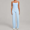 A woman wearing a light blue high-waist yoga and fitness tracksuit set.