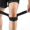 Black pressurized knee support sleeve applied to a person's lower leg.