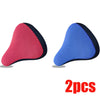 Two breathable 3D mesh bicycle saddle cushions in pink and blue.
