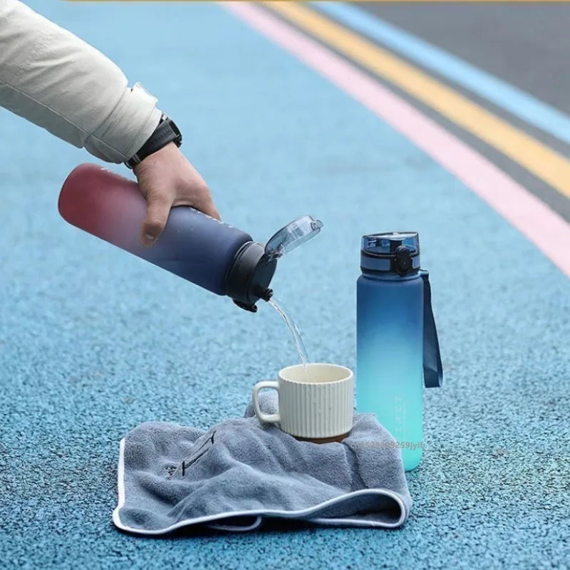 A hand pours water from a purple sports bottle into a white mug on a blue textured surface.