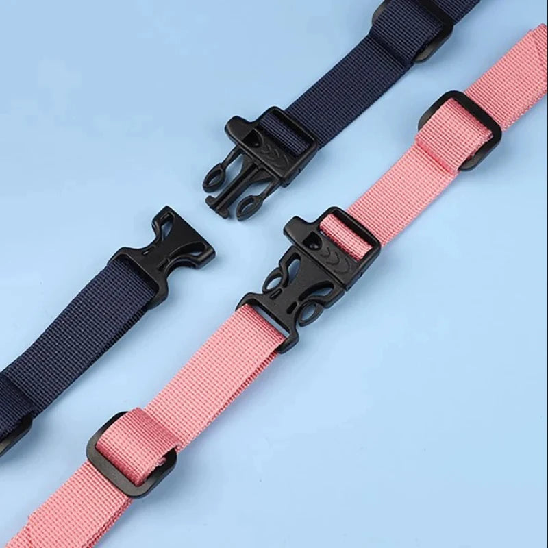 A pair of adjustable tactical backpack strap harnesses in black and pink.