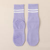 Pair of light purple grip socks with white stripes for Pilates, yoga, and barre