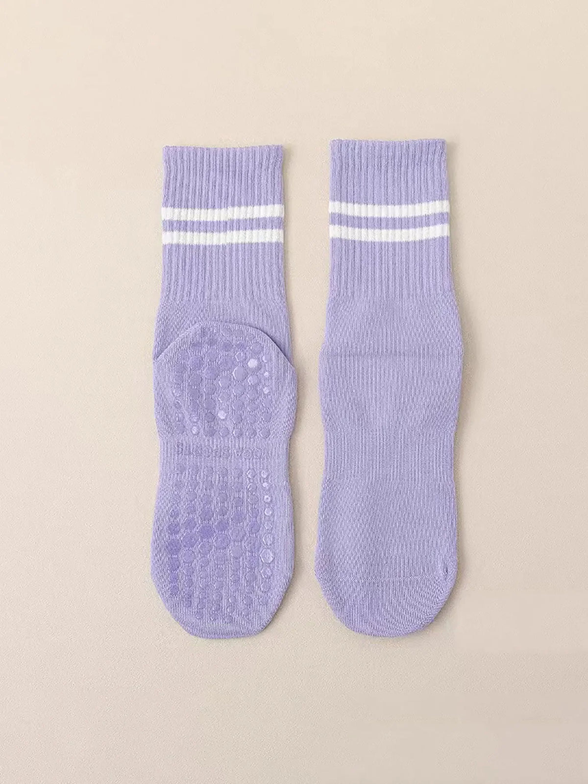 Pair of light purple grip socks with white stripes for Pilates, yoga, and barre