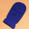 A royal blue tactical knit balaclava beanie hat shown against a light orange background.