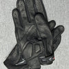 A pair of black genuine leather motorcycle motocross gloves shown against a gray background.