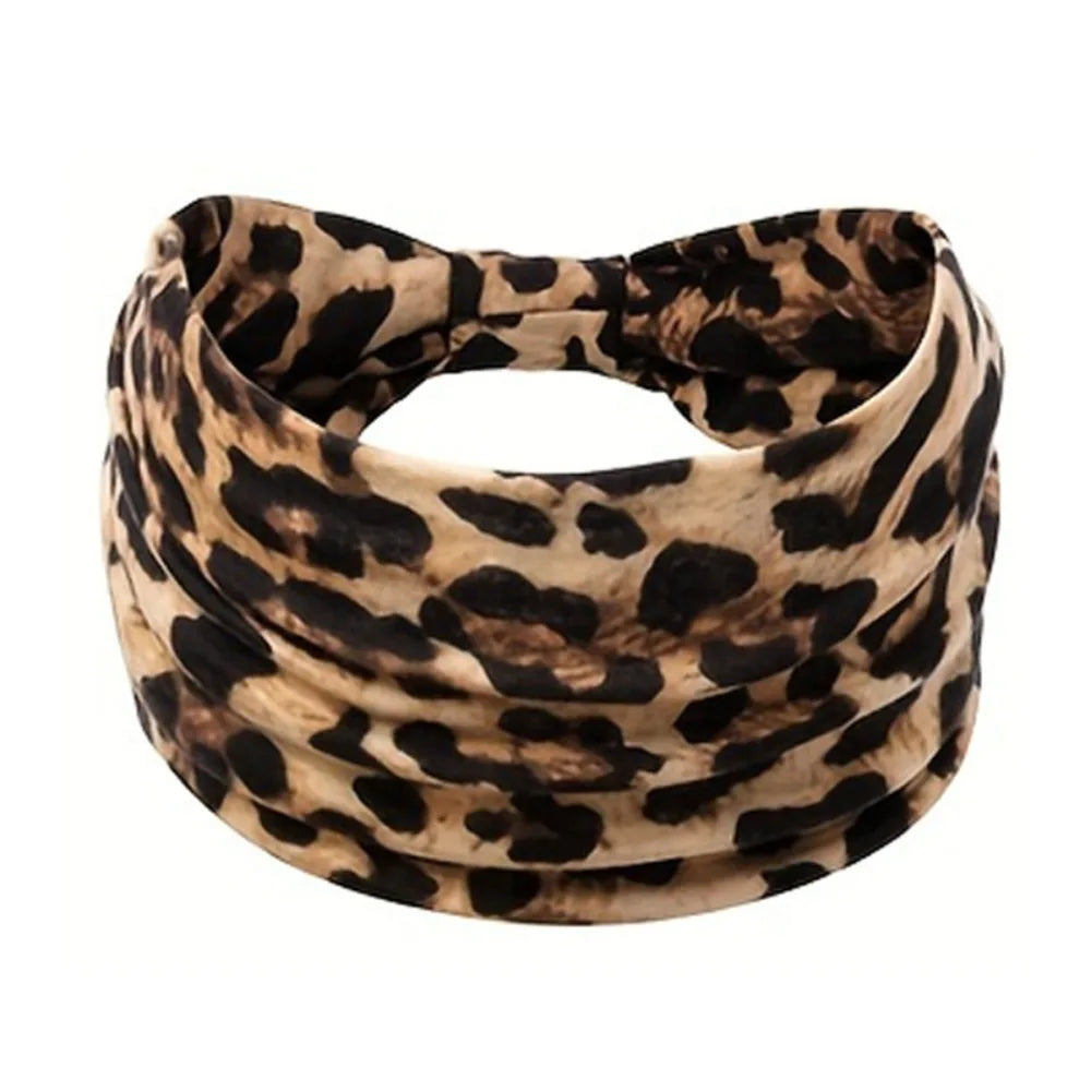 A black and tan leopard print fabric headband wrapped around the head.