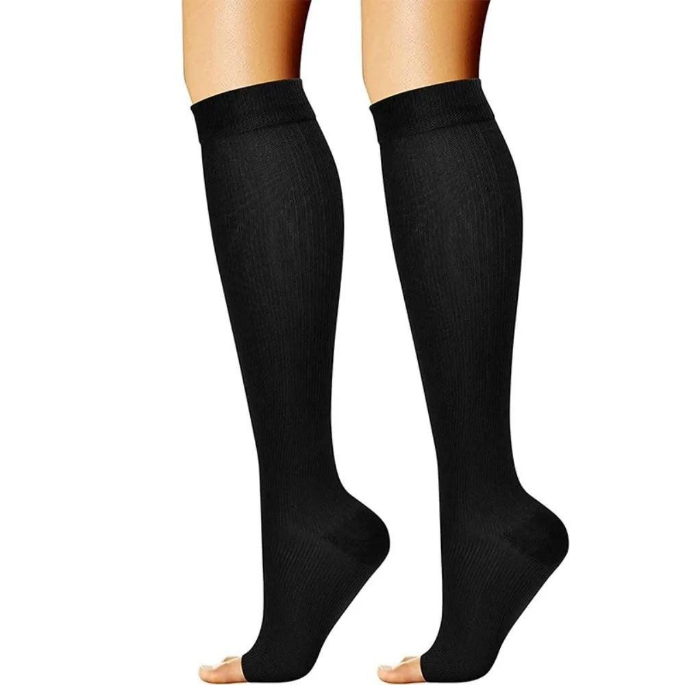 Pair of black medical grade compression socks shown on a person's legs.