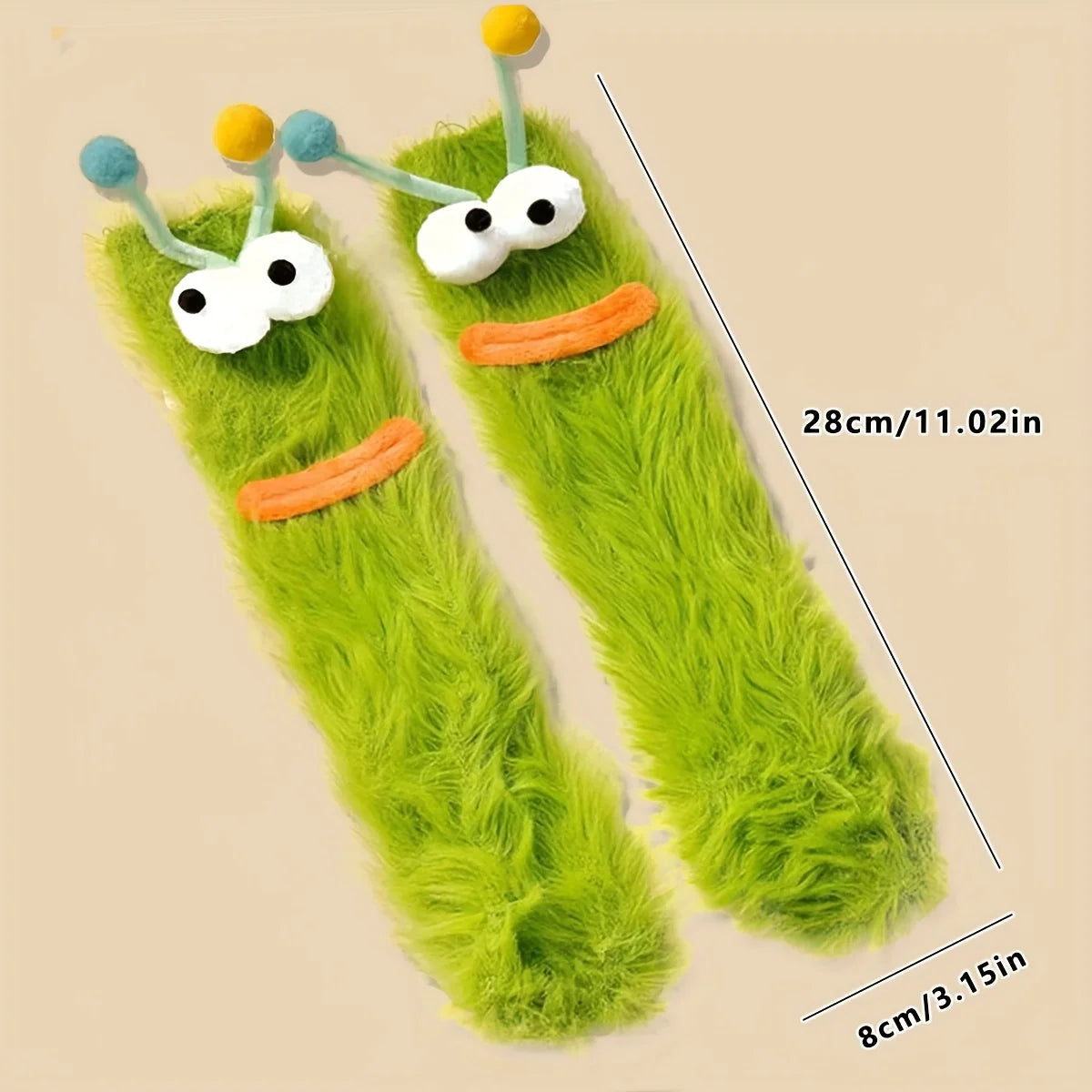 Pair of funny plush caterpillar floor socks in bright green with yellow and blue accents.