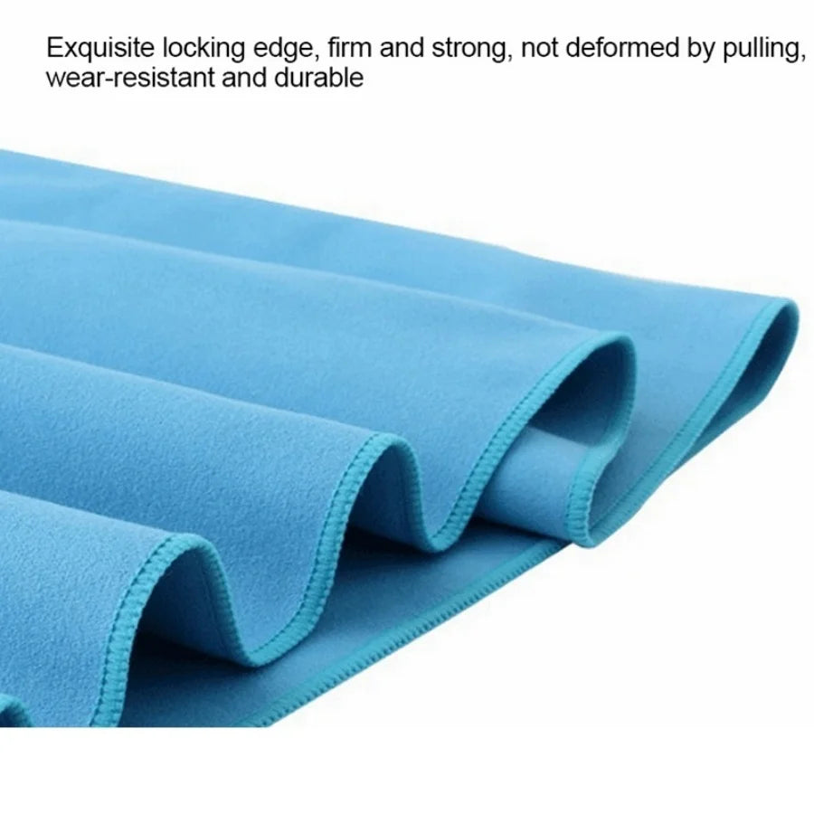 Folded light blue microfiber quick-dry beach towel showing its fabric texture and edge.