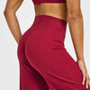 A model wearing red high-waist yoga pants, showing the fit and fabric.