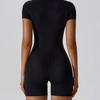 A black women's seamless yoga jumpsuit shown from the back.