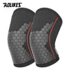 A pair of black knee sleeves for weightlifting and squats shown from the side.