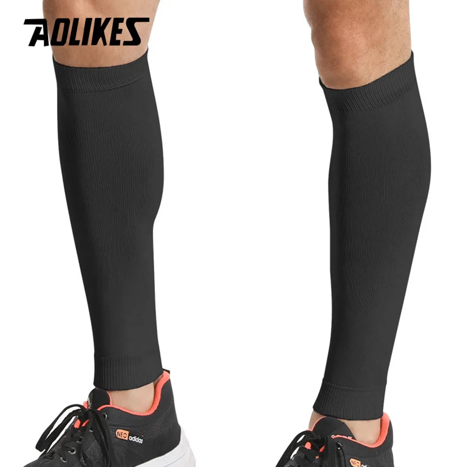 Black compression leg sleeves worn by a person, showing the full length of the garment.