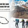 A pair of black eyeglasses is shown next to a group of people skiing in a snowy, mountainous landscape.