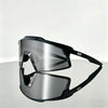 A pair of black sports sunglasses with mirrored lenses resting on a gray surface.