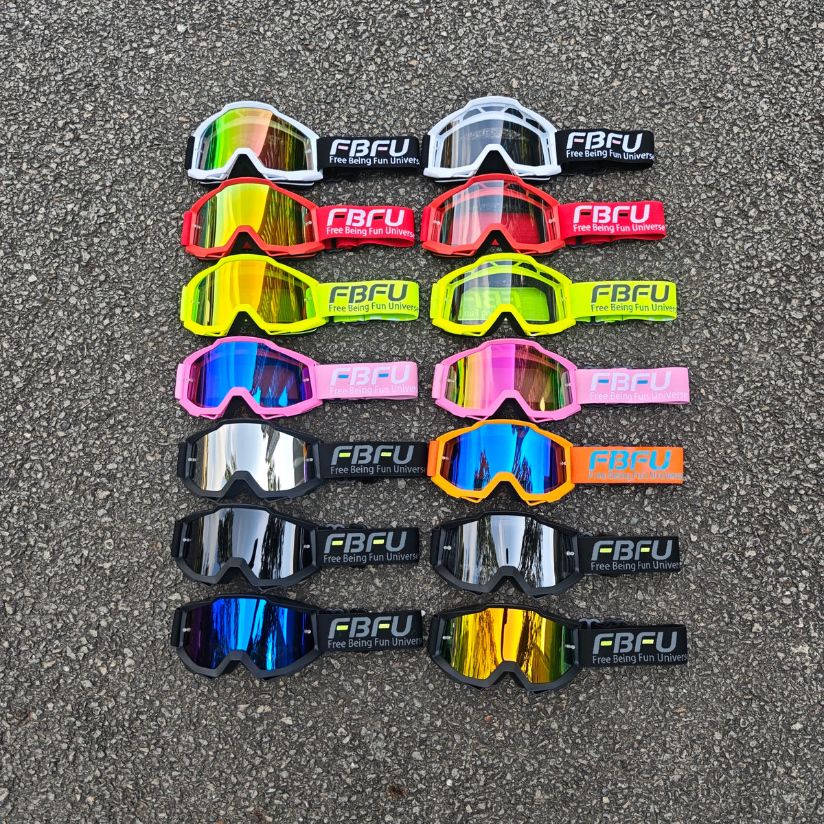 A collection of various colored sport-grade skiing goggles with FBFU branding displayed on asphalt.