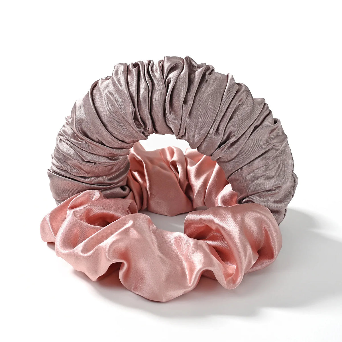 A headband made of draped, silky fabric in shades of mauve and dusty rose.