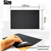 A hand applies a black self-adhesive leather repair patch onto a surface, demonstrating the powerful adhesive.