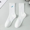A pair of white men's athletic crew socks with a blue embroidered design on the foot.
