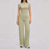 A woman wearing a light olive green women's premium fitness tracksuit top and matching pants.