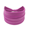 A wide, purple fabric headband or hair wrap for women.