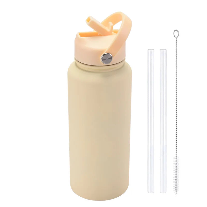 A beige stainless steel vacuum flask water bottle with a pink straw and a separate metal straw.