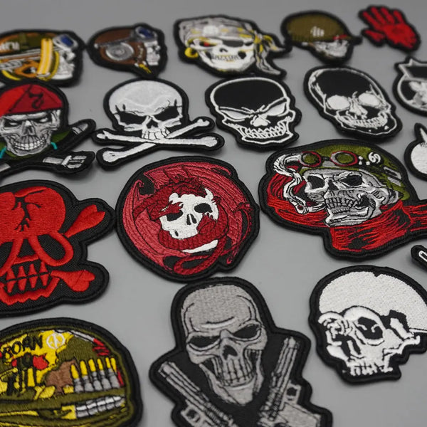 A collection of tactical embroidered skull patches in various colors and designs.