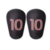A pair of black mini football shin guards for youth and adult players.