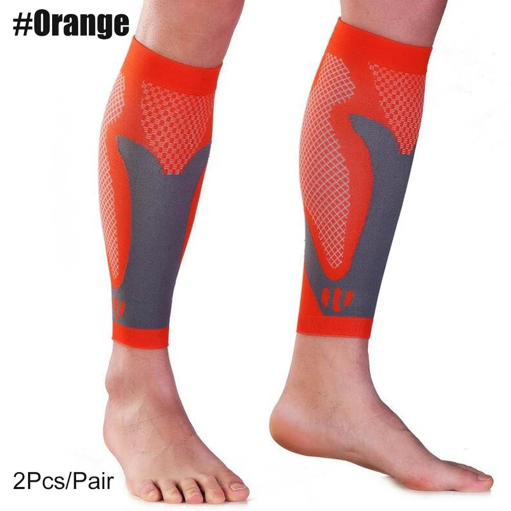 Pair of orange calf compression sleeves with gray and orange mesh fabric shown on a leg.