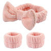 A set of pink microfiber spa headband and wristband featuring a fluffy texture.