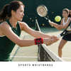 Une joueuse de tennis frappe une balle avec une raquette, portant des bracelets de sport.