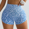 A model wears blue leopard print high-waist seamless shorts and a white cropped top.