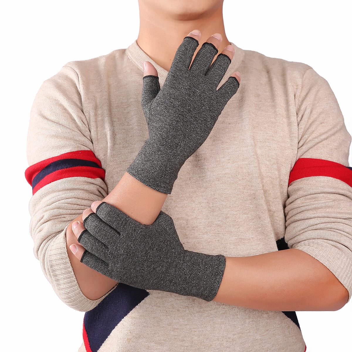 A person wearing gray fingerless compression gloves on their hands and wrists, with red and blue accents on the sleeves of a 
