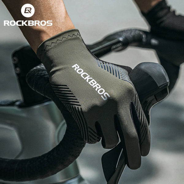 Close-up of a hand wearing black cycling performance gloves for mountain biking or road riding.