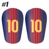 A pair of navy blue soccer shin guards with red stripes and yellow numbers 10