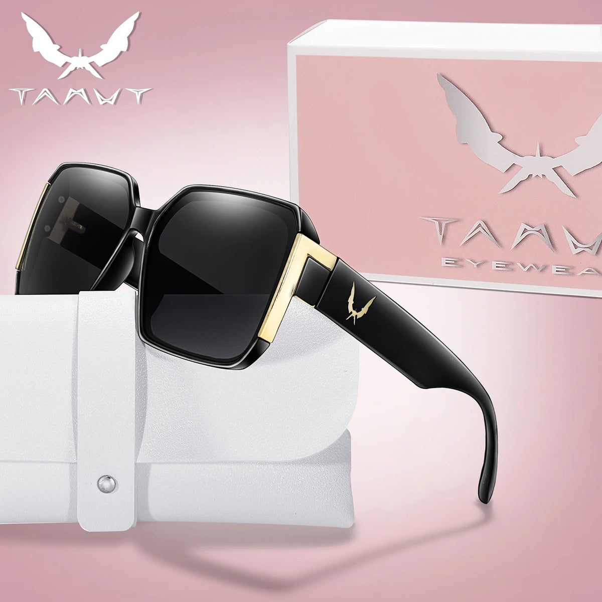 A pair of black and gold trendy square sunglasses resting on a white cloth next to their packaging box.
