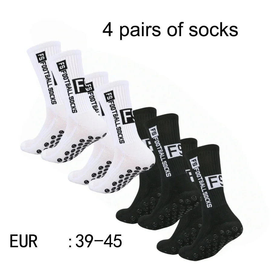 Four pairs of black and white men's athletic soccer socks with non-slip grip