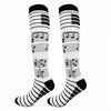 A pair of black and white compression elastic socks featuring musical notes patterns.