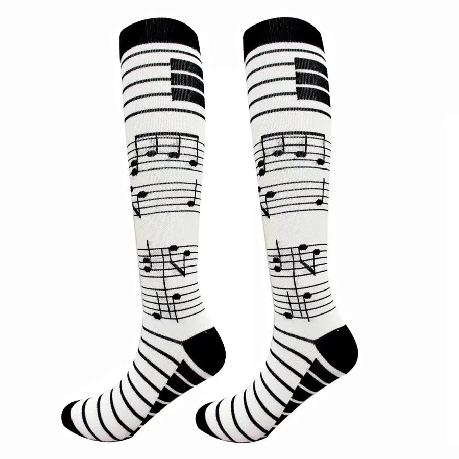 A pair of black and white compression elastic socks featuring musical notes patterns.