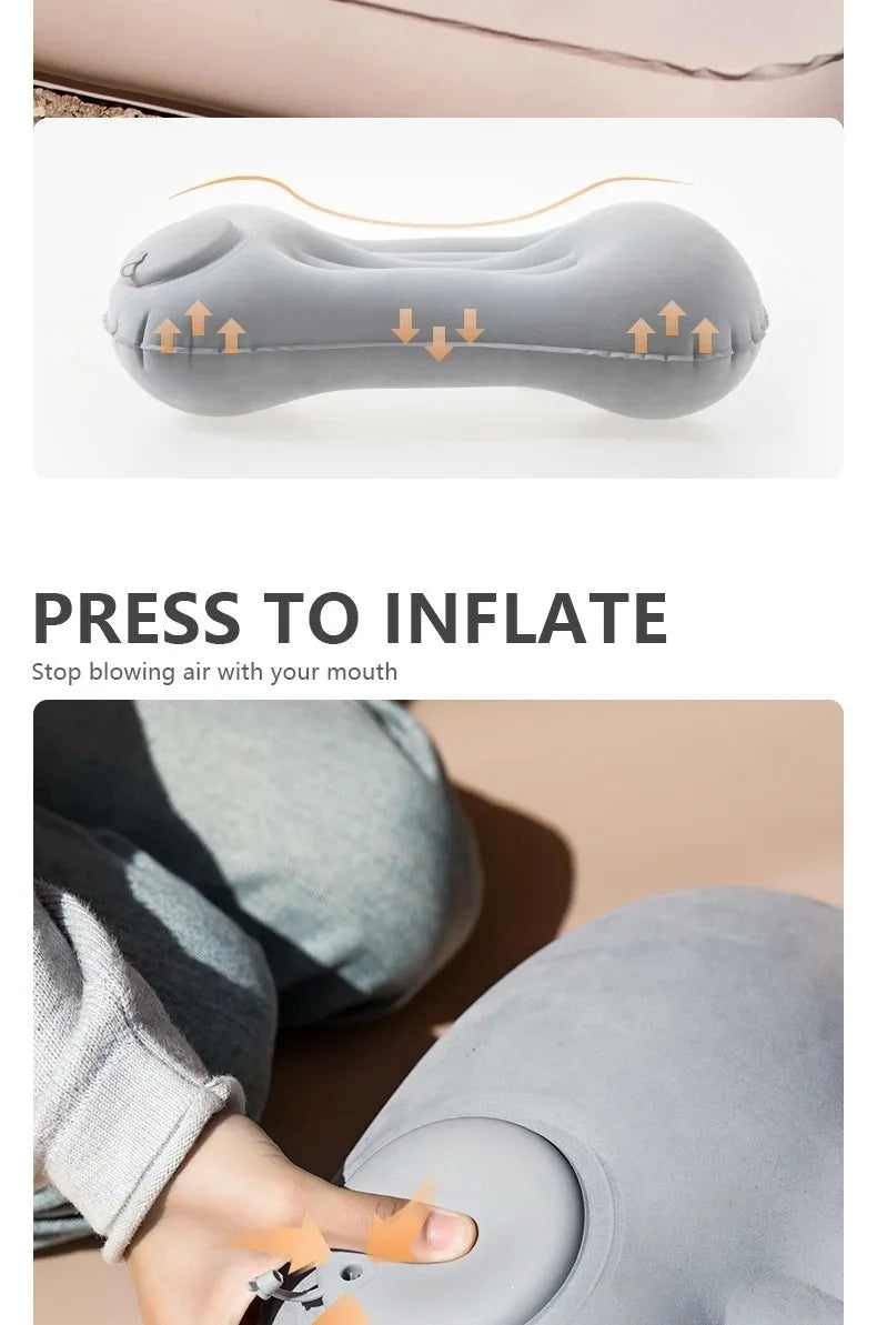A hand is pressing a portable inflatable camping pillow to inflate it for neck and lumbar support.