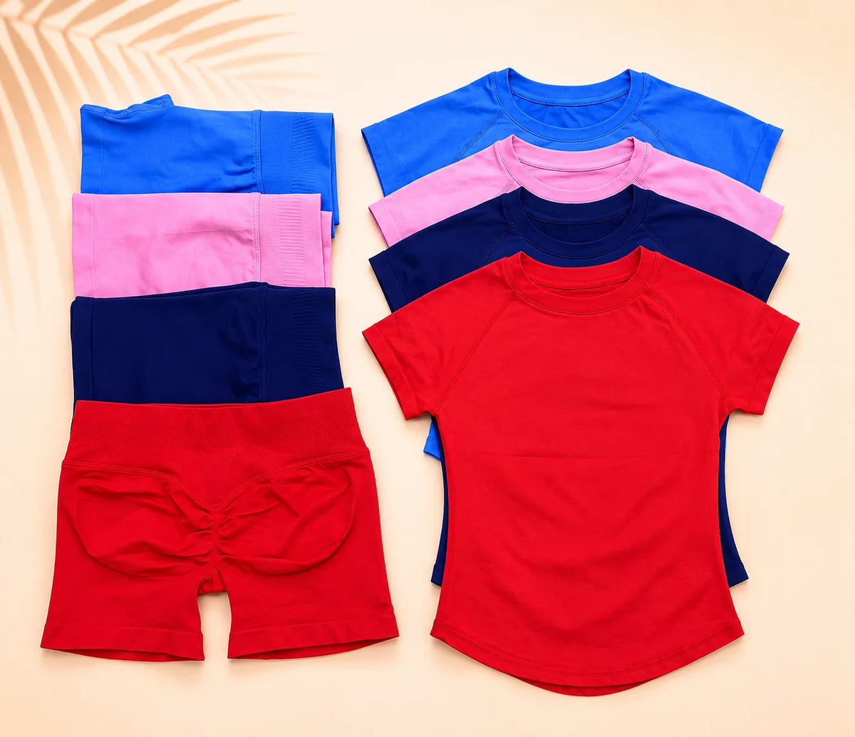 A set of seamless high-waist yoga tops and bottoms in various shades of blue, pink, and red.