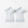 Pair of white therapeutic compression socks for foot and ankle pain relief